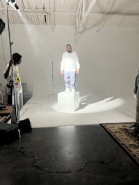a group of people standing in front of a camera in a studio